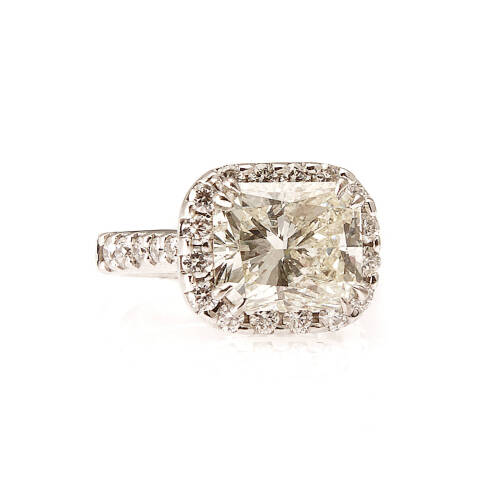 5.07 Radiant diamond cluster ring, double claw set with a radiant cut diamond centre of estimated weight. The decorative halo, shoulders and basket are claw set with thirty-two round brilliant cut diamonds of estimated total weight 0.93 carats. 18ct white