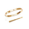 A gold Love bangle, Cartier. Serial number 757082. Front and back section of screw-on bangle decorated with screw motif. 18ct yellow gold. Weight 34.9 grams. Inside diameter 6.3cm. To be sold with gold tone screw driver.