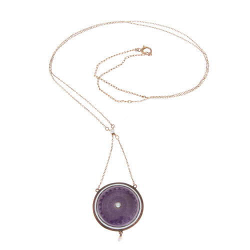 An Art Deco enamel and seed pearl pendant on chain, three seed pearls with decorative purple enamel disk pendant hung on a fine chain. 9ct gold. Weight 6.3 grams. Pendant length 2.5cm. Chain length 52cm.