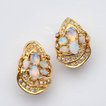 A pair of opal and diamond ajoure cluster earrings, ten claw set cabochon cut opals, accented with forty-four 8/8 cut diamonds of estimated total weight 0.66 carats. 18ct yellow gold . Weight 10.9 grams. Length 22mm. Gemologist's report available.
