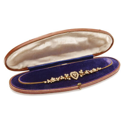 A Victorian seed pearl heart necklace, circa 1890. Necklace comprised of seventy-three bead set half round pearls in decorative clusters and trefoil motifs hung a on neck chain. 15ct rose gold. Weight 15.5 grams. Length 37cm. Original box. Gemologist's re