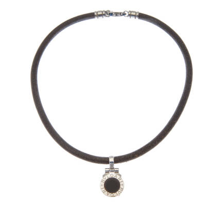 A Bulgari Bulgari disk pendant on cord, Bulgari. Disk pendant with black onyx inlay hung on a black leather cord. 18ct white gold. Pendant length 3cm. Cord length 37.5cm. Original box.