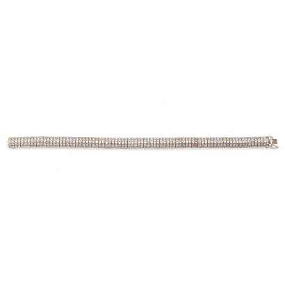 A diamond bracelet, an articulated bar bracelet comprising of four hundred and ten bead set round brilliant cut diamonds of estimated total weight 6.15 carats. 18ct white gold. Weight 32.5 grams. Length 17.7cm. Gemologist's report available.