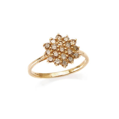 A champagne diamond cluster ring, nineteen claw set round brilliant cut champagne diamonds of estimated total weight 0.60 carats. 9ct yellow gold. Weight 2.9 grams. Ring size T.