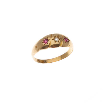 A Victorian diamond and ruby ring, a gypsy set old cut diamond centre, gypsy set old cut ruby either side. 18ct yellow gold. Weight 2.2 grams. Ring size J1/2.