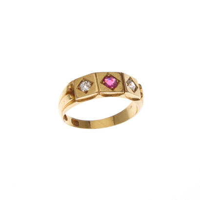 A ruby and diamond ring, bead set old mine cut ruby centre estimated weight 0.20 carat, with a bead set old mine cut diamond either side of estimated total weight 0.16 carats. 18ct yellow gold. 3.9 grams. Ring size J.