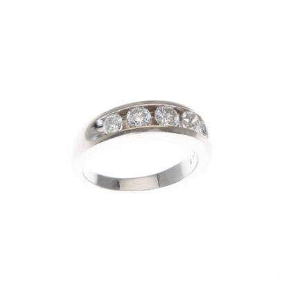 A diamond band ring, five graduating channel set round brilliant cut diamonds of estimated total weight 1.0 carats. 14ct white gold. Weight 5.6 grams. Ring size M1/2. Gemologist's report available.