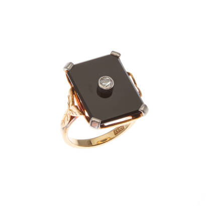 An antique onyx and diamond ring, square onyx plaque set with one round diamond. Weight 5.0 grams. Rings size H.