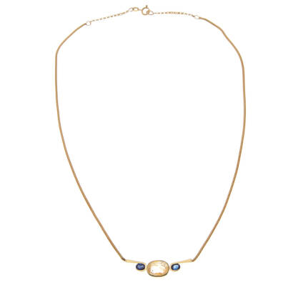 A contemporary sapphire necklace, bezel set cushion cut yellow sapphire centre of estimated weight 4.96 carat, accented either side by semi bezel set oval cut sapphires of estimated total weight 0.85 carats. 18ct yellow gold. Weight 13.0 grams. Length of 