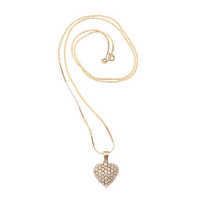 A diamond heart pendant on chain, the heart pendant is comprised of fifty-seven bead set round brilliant cut diamonds of estimated total weight 1.50 carats, hung on fine chain. 14ct yellow gold. Weight 7.3 grams. Pendant length 2.5cm. Chain length 60cm. G