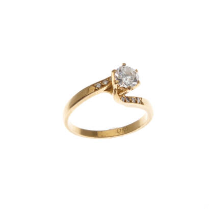A diamond ring, claw set round brilliant cut diamond centre of estimated weight 0.51 carat, accented with eight bead set round cut diamonds on shoulders of estimated total weight 0.08 carats. 18ct yellow gold. Weight 3.0 grams. Ring size K1/2. Gemologist'