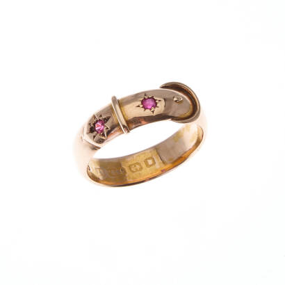 A ruby ring, two gypsy set rubies in belt motif. 15ct yellow gold. Weight 2.5 grams. Size O1/2. Birmingham hallmarks.