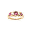 A Victorian ruby and diamond bridge ring, three claw set round rubies and two old cut diamonds in graduated mount. 18ct yellow gold. Weight 3.9 grams. Size P.