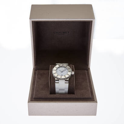 A Lady's stainless steel Class One wristwatch, Chaumet. 33mm. Quartz. Ref: 622c. Serial number 10004. White dial with diamond markers. Uni-directional diamond and enamel bezel. Original white rubber strap. Case, dial, clasp signed. Box.