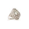 An Edwardian 'Belle epoque' style diamond ring, claw set old European cut centre diamond of estimated weight 0.80 carat, surrounded by twenty pave set old Swiss cut diamonds of estimated total weight 0.70 carats, in ornate geometric design. Platinum. Weig