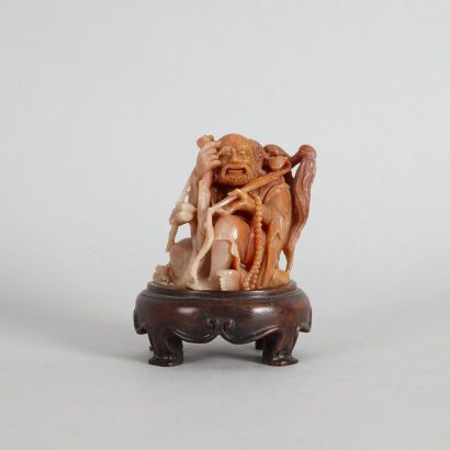 A Chinese Stone Carved Lohan Ornament with wooden base