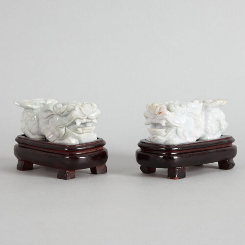 A Pair of Chinese Jade 'Lion' Carvings (with original bases)