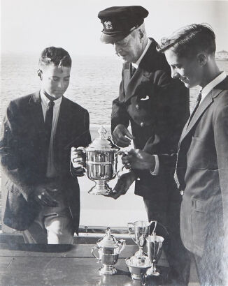 GEORGE SILK Harold Vanderbilt presents cup to young sailors