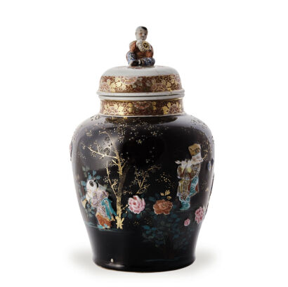 A Japanese Meiji Period Black Ground Famille Rose Lidded Jar decorated with playing boy (damage on lid)