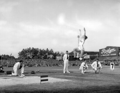 Yvette Williams breaks the New Zealand long jump record by jumping 20 ft. and 3 in. at Carisbrook, Dunedin, 1950