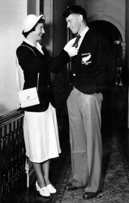 Olympian Yvette Williams straightening fellow athlete J.M. Holland's tie, 1952