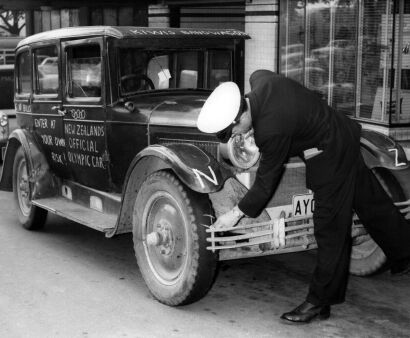 "New Zealand's Official Olympic Car" bring chalked by a Melbourne policeman, 1956