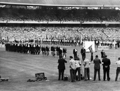 The New Zealand team salutes as it marches past the Duke of Edinburgh during the opening ceremony in Melbourne, 1956