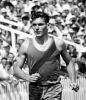 Peter Snell rounds Eden Park on his victory lap after winning the 880 yd race, 1962