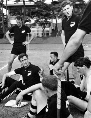 Hockey captain Phil Bygrave gives members of his team a pep-talk during their training, 1964