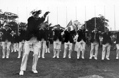 New Zealand hockey team captain Phil Bygrave leads his team as they perform the Haka dance for spectators at the main Olympic Village in Tokyo, 1964