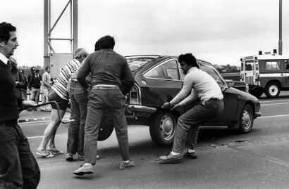 Police and members of the public in roadblock on Auckland Harbour Bridge move protester cars from road