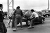 Police and members of the public in roadblock on Auckland Harbour Bridge move protester cars from road