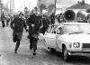 Police officers chase after demonstrators outside Athletic Park