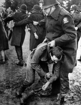 Police officers arrest demonstrators on the Gisborne golf course after the park fence was stormed