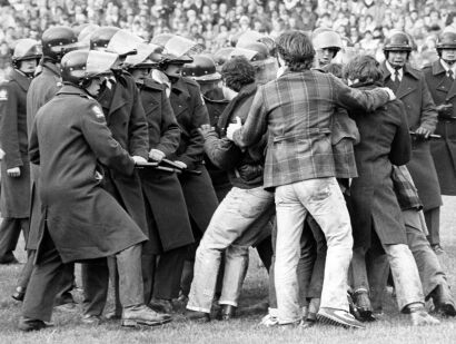 A scuffle between protesters and police officers during a match at Lancaster Park in Christchurch