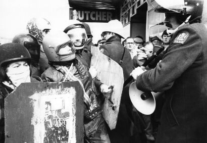 Protesters and police officers dressed in riot gear on Adelaide Road in Wellington