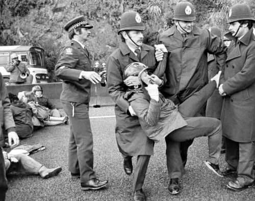 Police officers arrest a protester during a demonstration in Christchurch