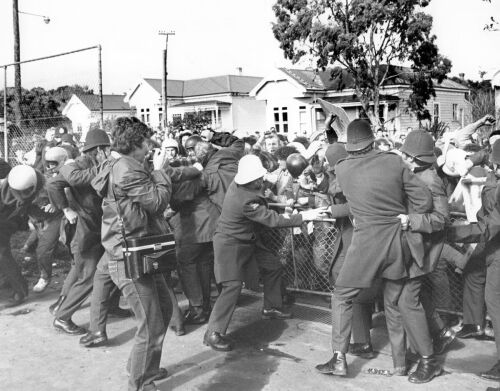 Protesters attempt to break through a police barricade near Eden Park