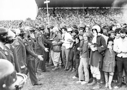 Protesters and police officers meet on the field