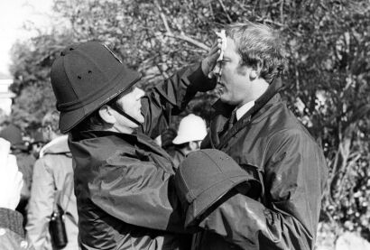 A police office administers first aid on a colleague