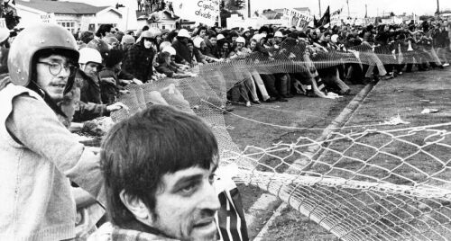 Protesters tear down a barricade outside Hamilton Rugby Park