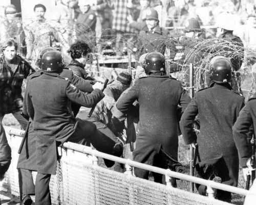 Police officers and riot squad members move in to arrest demonstrators at Athletic Park