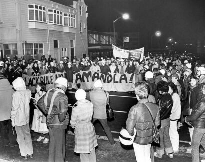 Anti-apartheid protesters gather outside the Air New Zealand freight hanger