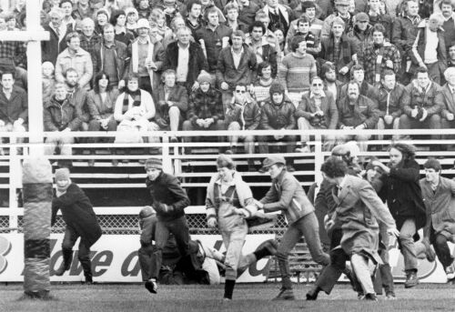 Protesters run onto the field during a match