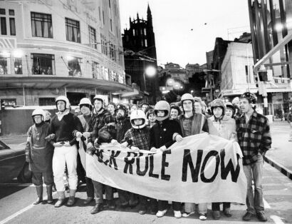 Anti-tour demonstrators create a blockade to stop traffic during a protest