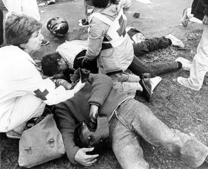 Two protesters are treated by first aid members before being taken to hospital after confrontation with police officers