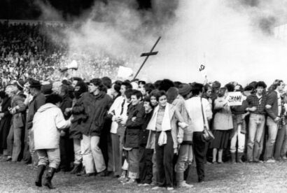 Demonstrators at the Hamilton Rugby Grounds lock arms to form a wall of bodies during the confrontation