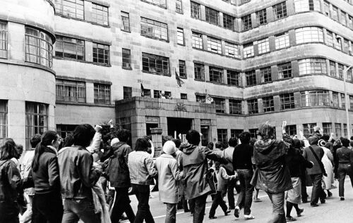 Anti-tour protestors march in the streets during a public demonstration