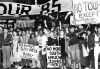 Protesters gathered in the street with signs for the No Tour March in Auckland