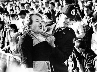 A police officer removes an anti-tour protester from Eden Park